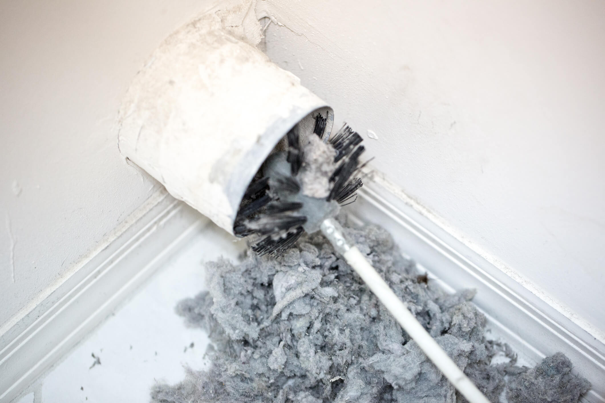 Brush and auger cleaning lint from dryer vent